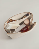 Open pouch with cosmetics and brushes inside