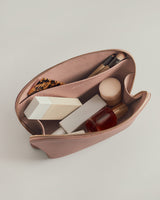 Open pouch with cosmetics and brushes inside