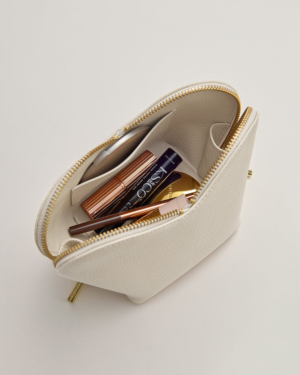 Open pouch with cosmetics visible inside