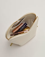 Open pouch with cosmetics visible inside
