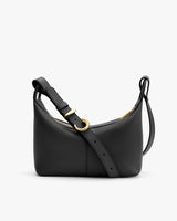 A small handbag with an adjustable strap and zipper closure.