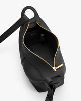 Open handbag with gold zipper and shoulder strap.