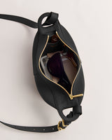 Open handbag with sunglasses and other items inside