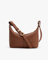 A shoulder bag with an adjustable strap and gold buckle detail.