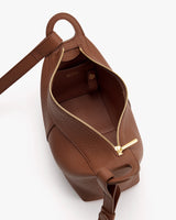 Open handbag with a visible zipper and strap.