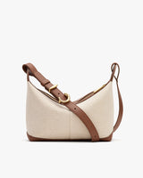 A shoulder bag with a curved shape and adjustable strap.
