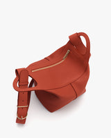 Sleek bag with top zipper and adjustable strap.