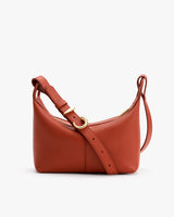 Shoulder bag with adjustable strap and curved shape