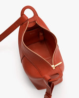 Open handbag with a visible zipper and strap.