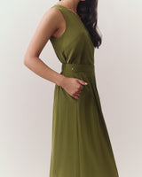 Person wearing sleeveless top and wide-leg pants standing indoors