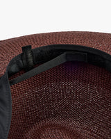 Inside view of a hat with adjustable strap and woven texture.