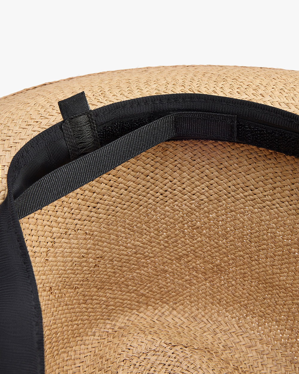 Interior view of a woven hat with a black band.