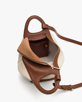 Open handbag with visible interior pocket and gold zipper on a white background.