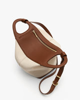 Two-tone tote bag with zipper pocket and adjustable strap.