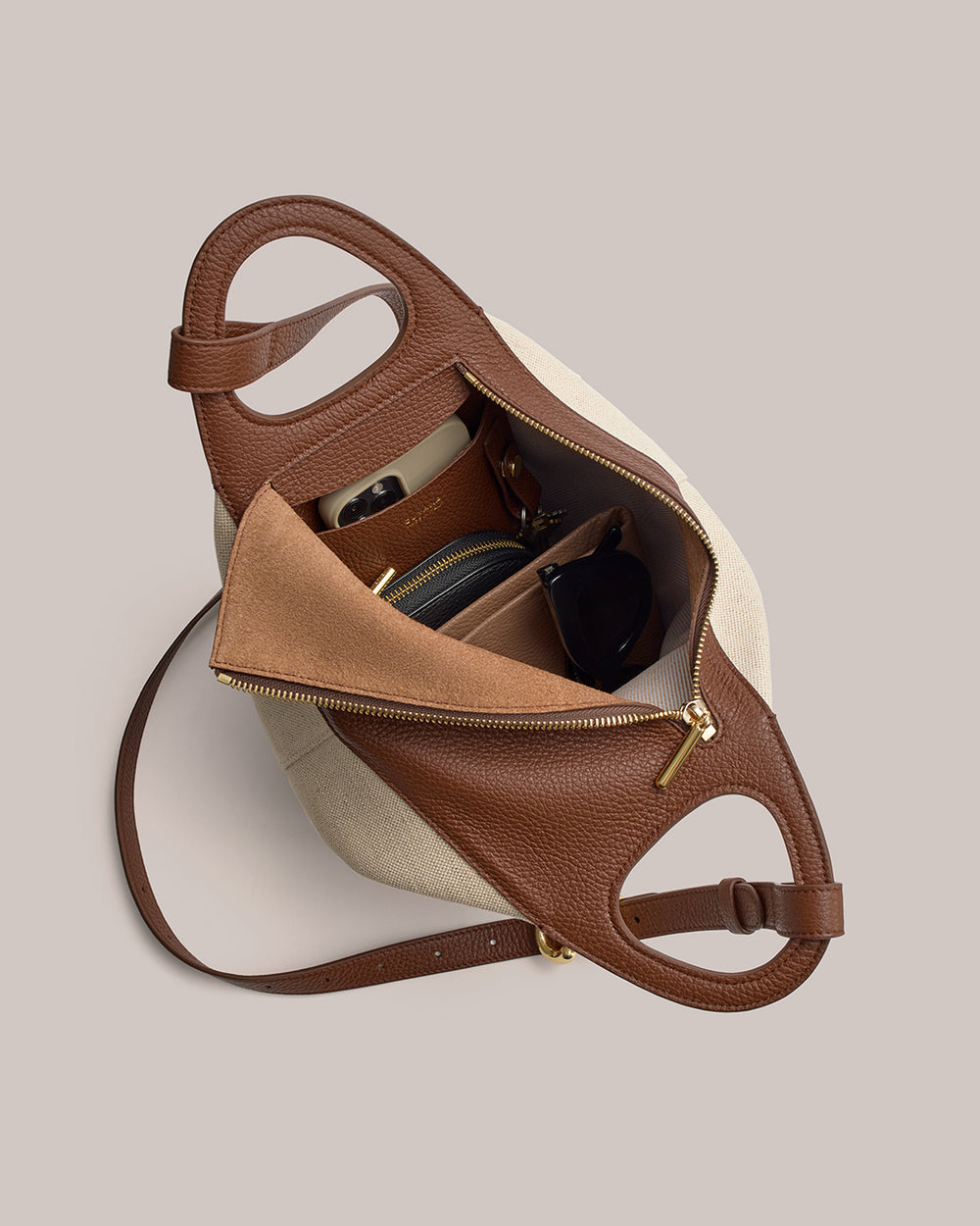 Paloma Bag (Linen) Open handbag with items inside including a wallet and sunglasses.