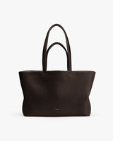 A large tote bag with long handles on a plain background.