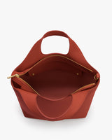 Open-top handbag with a handle and pocket inside.