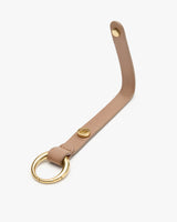 Leather key holder with metal ring and snap button.