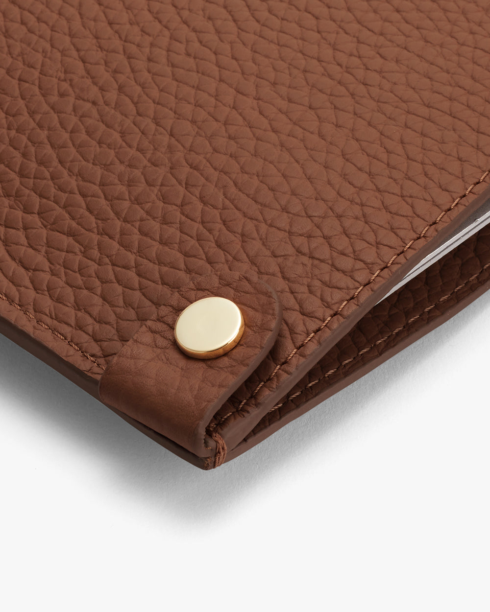 System Laptop Sleeve 13-inch Close-up of textured leather laptop sleeve with button detail