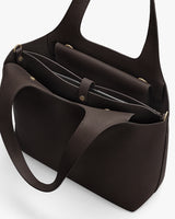 Handbag with open compartments and handles