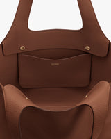 Open tote bag with interior pocket and brand logo inside