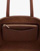 Open pouch with a visible inner zippered pocket.