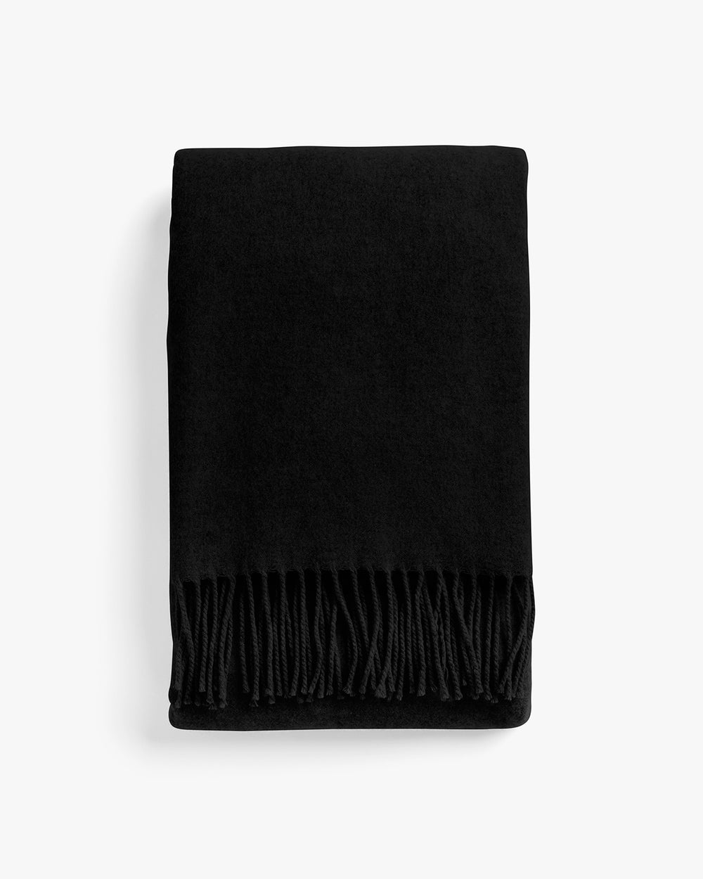 Folded blanket with fringe on top edge.