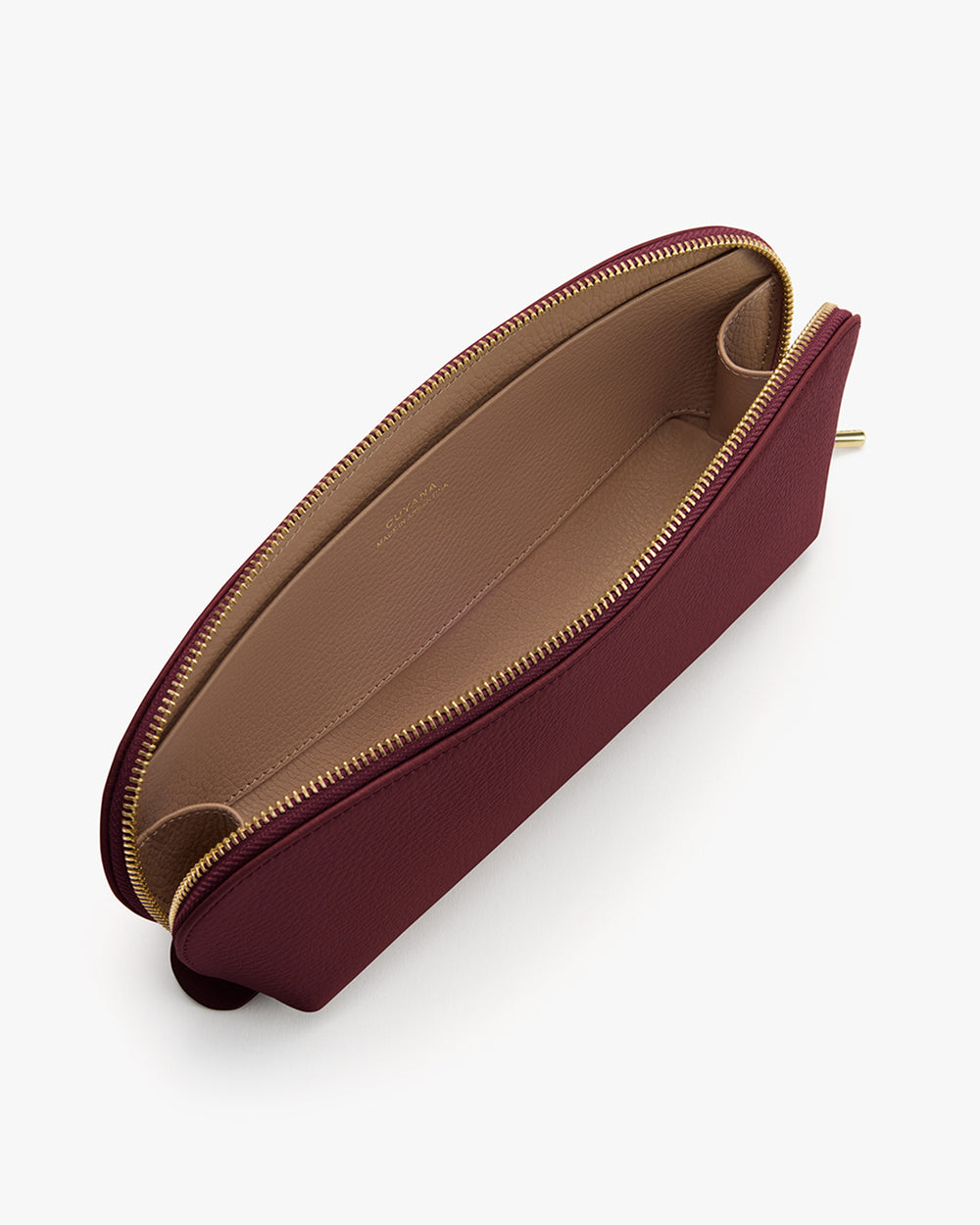 Beauty Case Open zipper pouch with spacious interior and divided compartments.