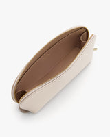 A top view of an open clutch bag with a visible zipper.