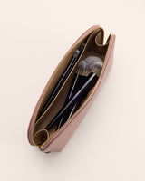 Open makeup pouch with brushes inside.