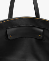 Open travel bag with handles and visible zipper edge