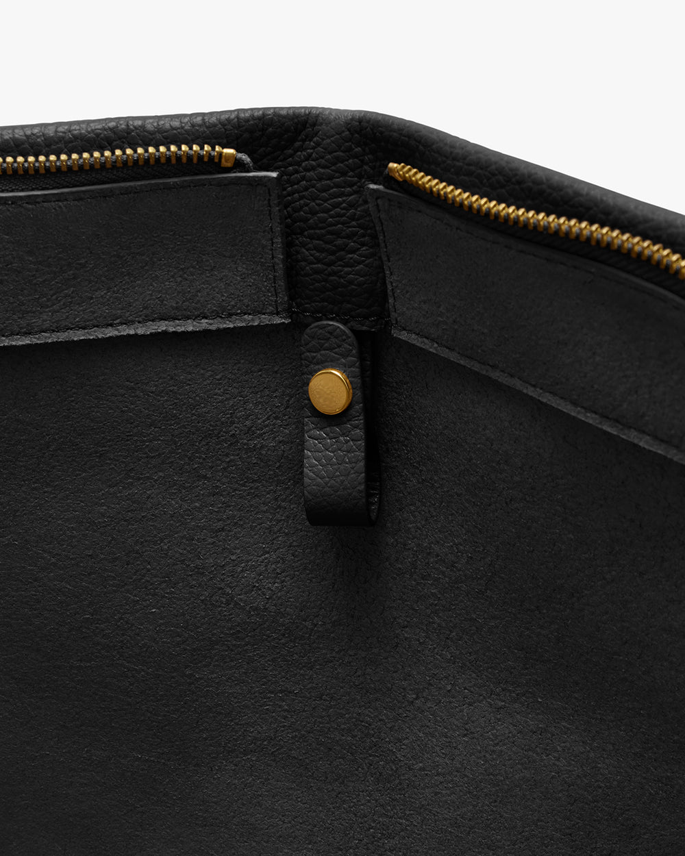 Open bag with zipper and button detail inside