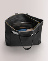 Large open tote with organized interior pockets and visible contents.