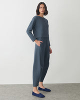 Person wearing a matching set with long sleeves and pants, standing on a plain background.