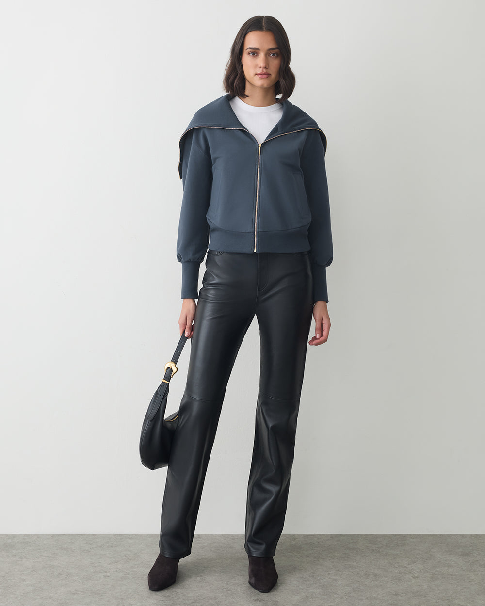 Fleece Oversized Collar Sweatshirt Person wearing jacket and leather pants holding a handbag.
