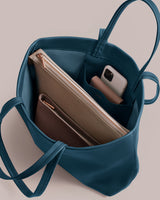 Open tote bag with a pouch, wallet, and smartphone inside.