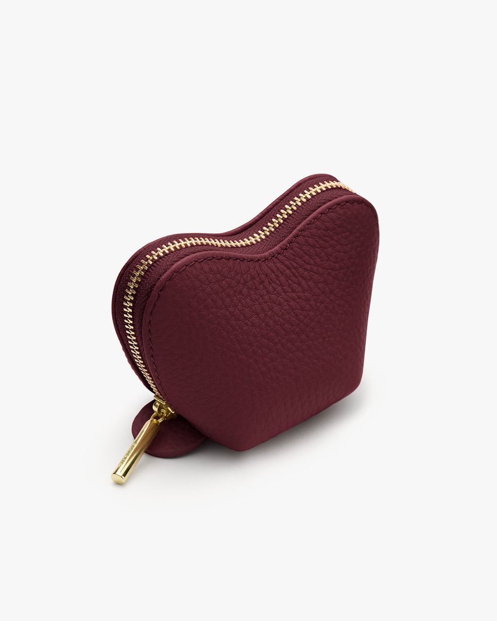 Tiny Heart Case Heart-shaped small zippered pouch with a textured surface.
