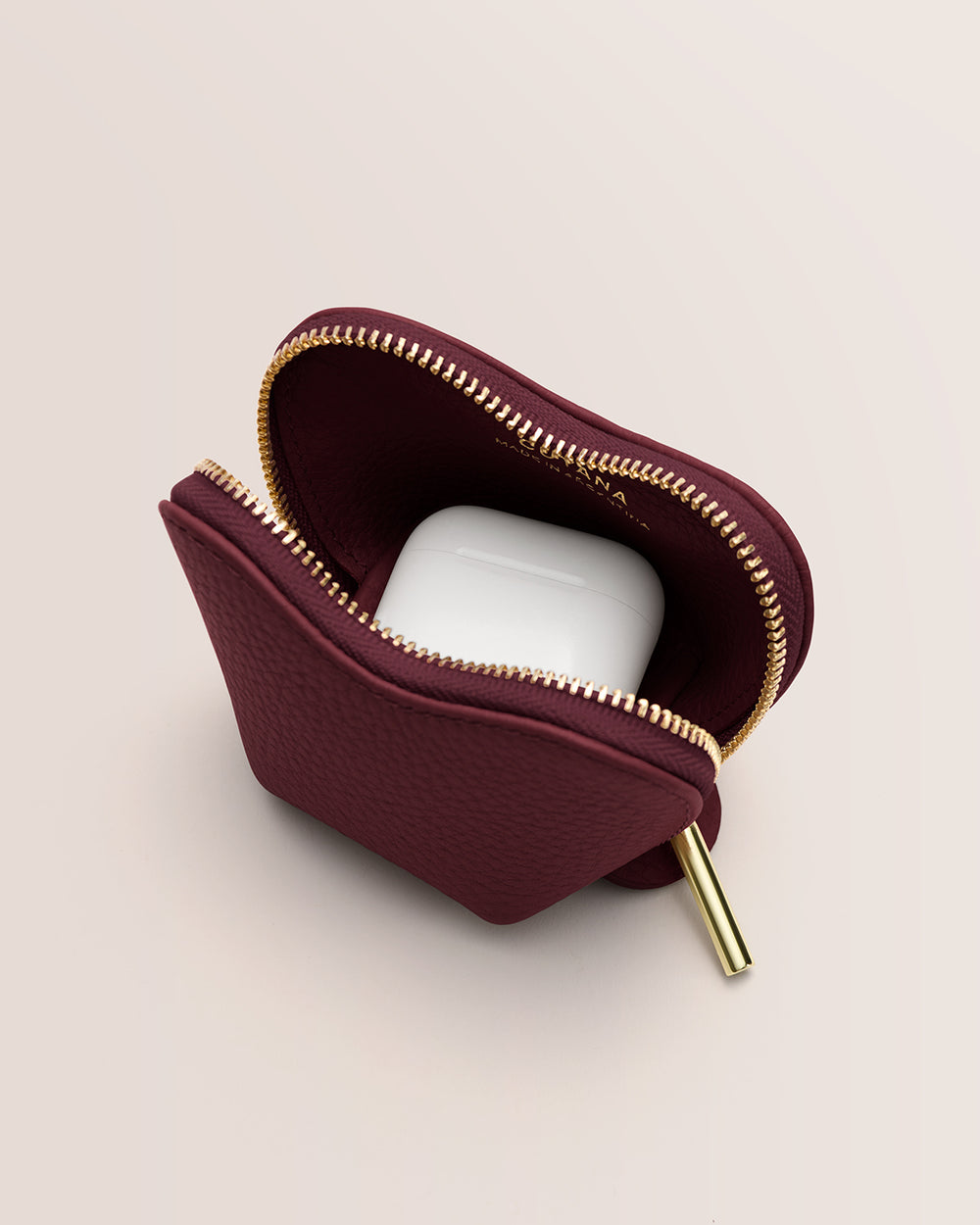 Tiny Heart Case Pouch with a zipper partially open showing wireless earbuds inside.