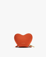 Heart-shaped leather pouch with a zipper at the bottom.