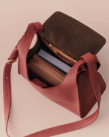 Open handbag with two zippered compartments and a shoulder strap.