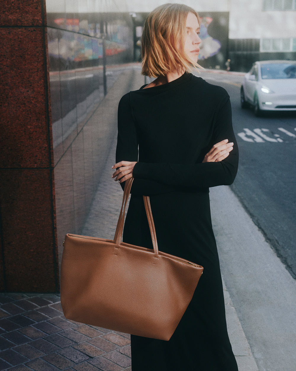Classic Easy Zipper Tote Person holding a tote bag standing on a city sidewalk.