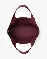 Open tote bag with wide handles in a top-down view.