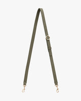Adjustable handbag strap with metal clasps.