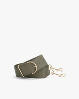 Bag strap with metal buckle and clips on a plain background.