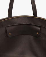 Close-up of an open travel bag with handles and a zippered top.