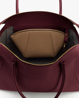 Open handbag with a zippered pouch inside.
