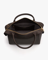 Open handbag with zipper and two handles, showing interior compartment.