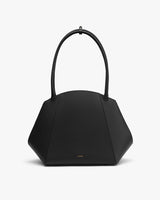 Geometric handbag with two handles on display.