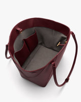 Open tote bag with interior pockets and long handles.