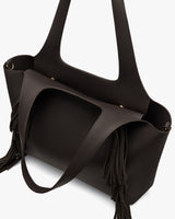Tote bag with fringe details and two handles.